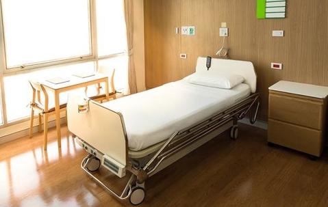 Hospital bed in a well lit room.